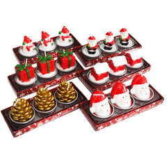 Set of Christmas-themed candles in a decorative box on a white background