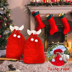 Red Christmas stockings with white trim hanging by a fireplace and decorated tree.