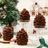 Chocolate pine cone candles on a festive background with Christmas decorations.