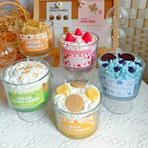 Set of small dessert jars with various flavors on a textured surface.