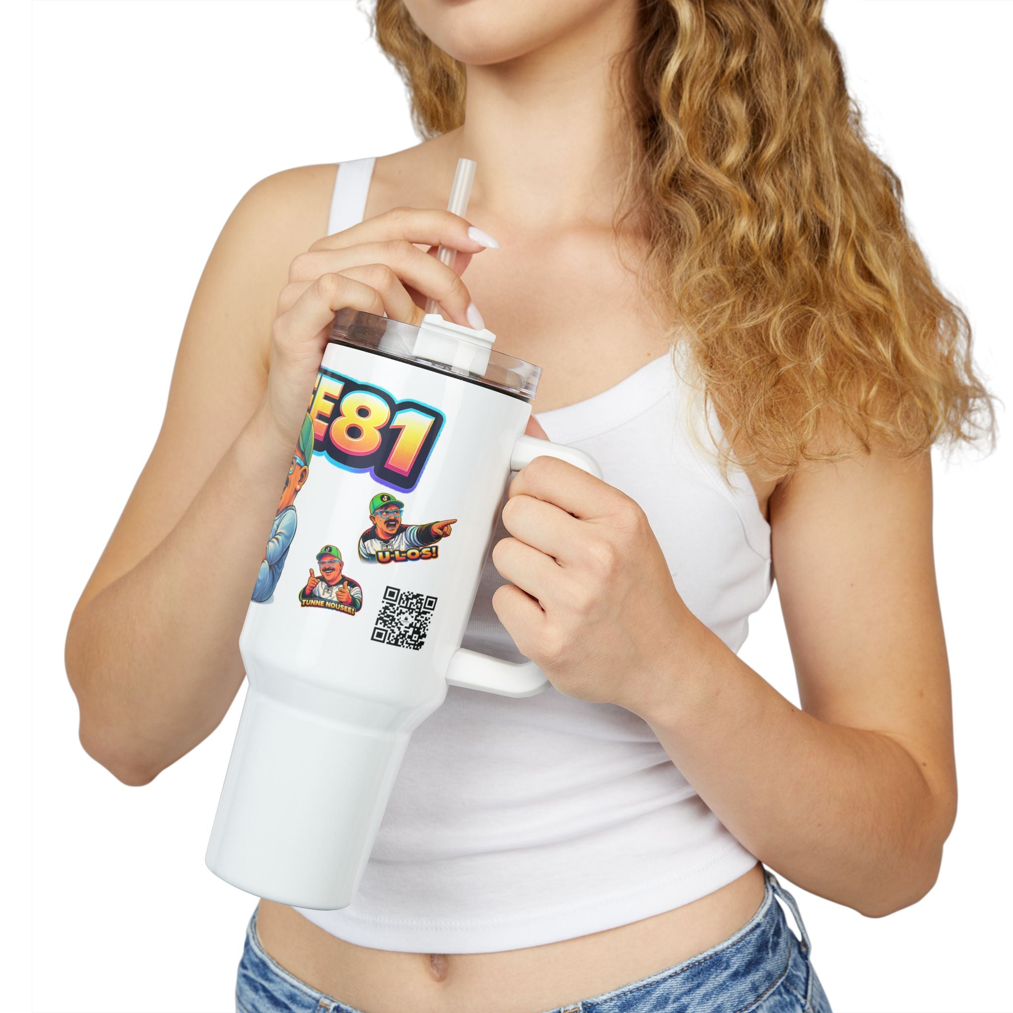 Person holding a white tumbler with colorful graphics and text