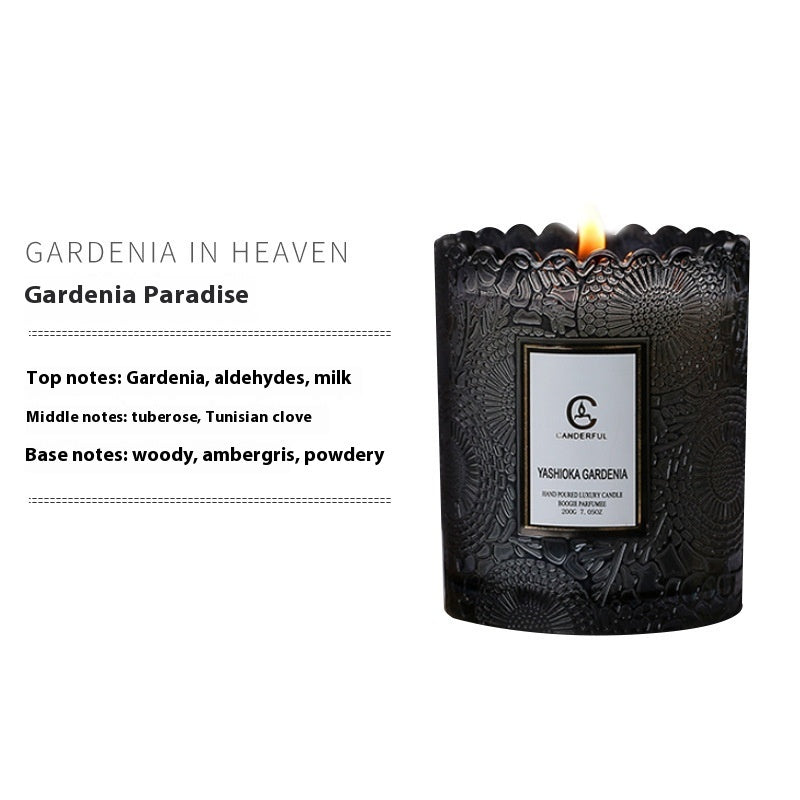 Black candle with intricate design and 'Yashika' branding on a white background, featuring product details.