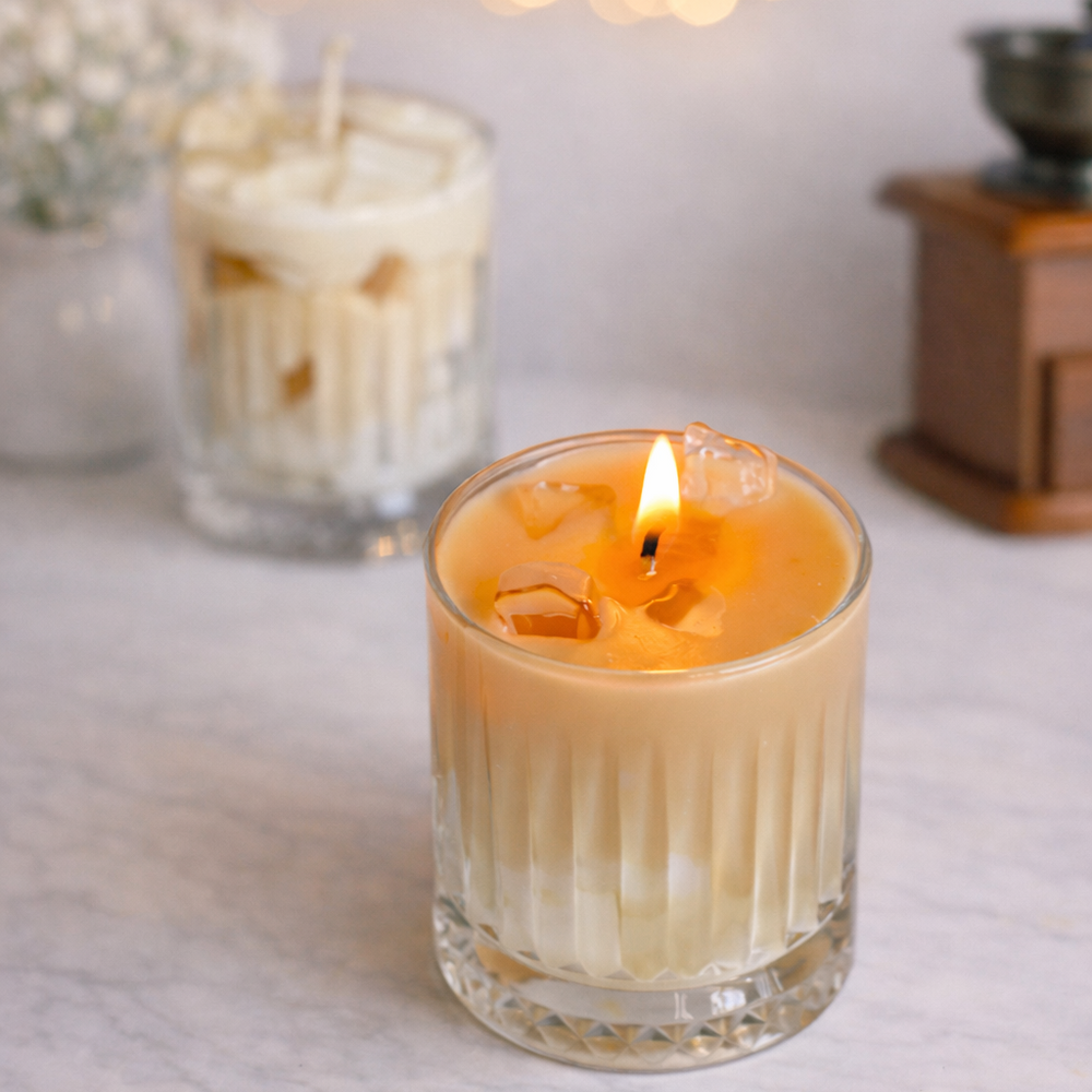Candle in a glass holder with blurred string lights in the background