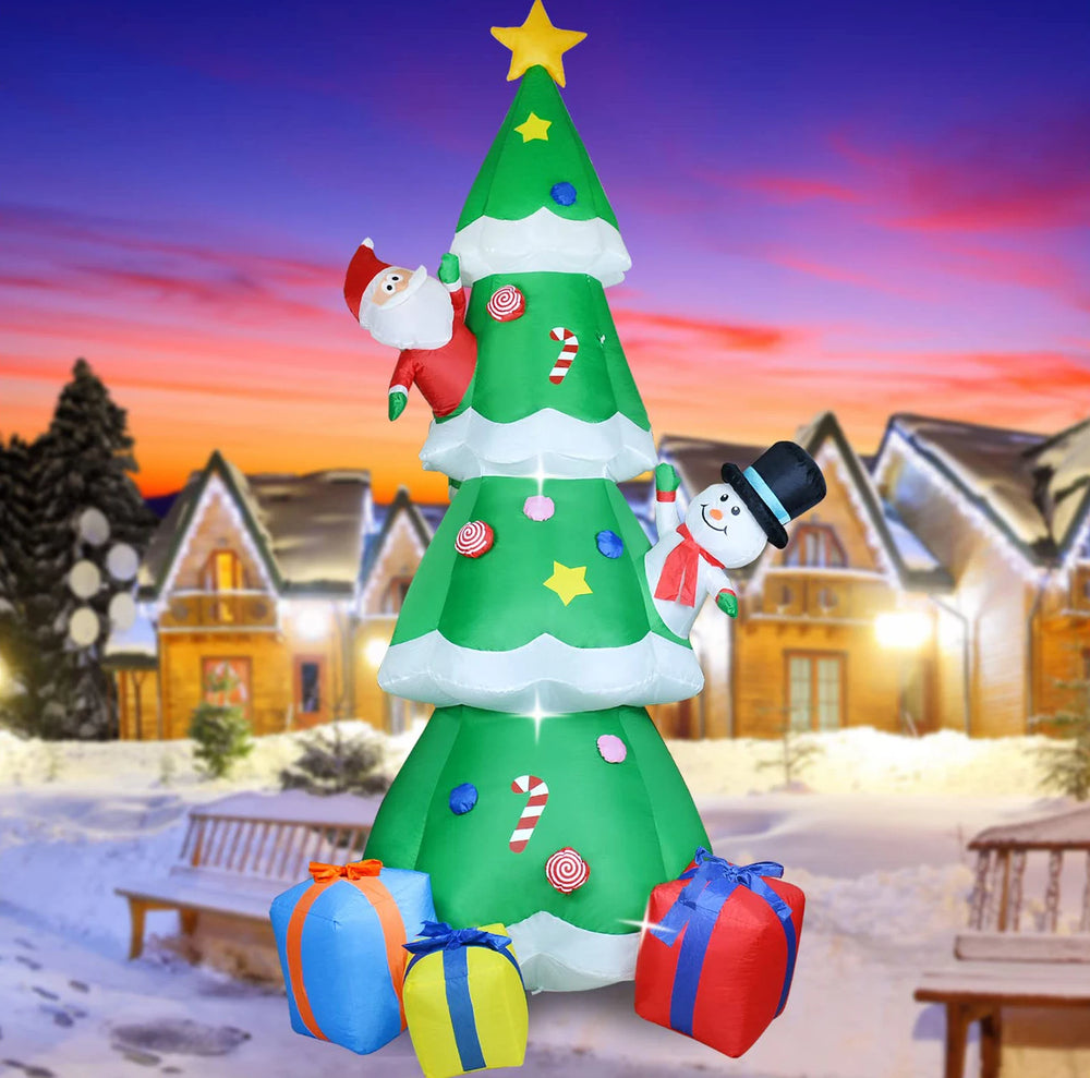 Inflatable Christmas tree with Santa Claus, snowman, and presents against a snowy village background