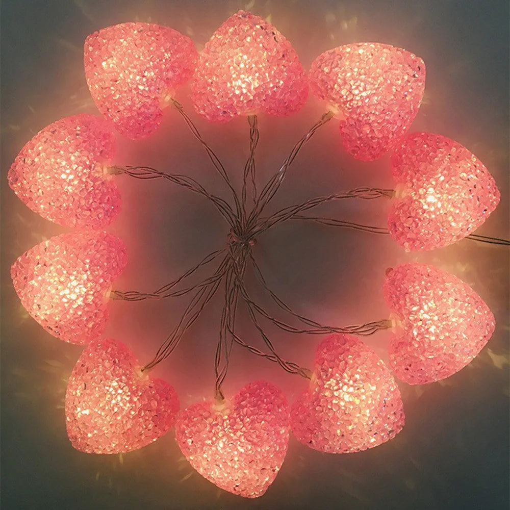 Pink glittery heart-shaped lights arranged in a circular pattern.