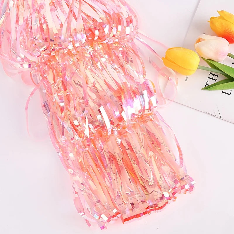 Pink tinsel with tulips on a white surface