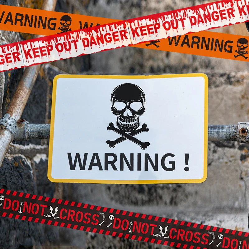 Warning sign with skull and crossbones symbol surrounded by caution tape on a rocky background