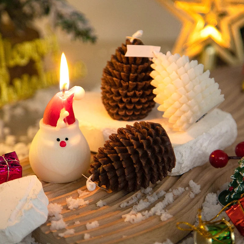 Decorative Christmas scene with candles, pine cones, and a Santa Claus figure on a wooden surface.