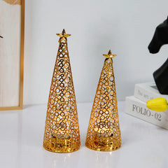 Two gold cone-shaped decorative items with star tops on a white surface.