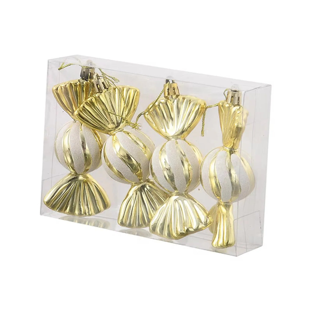 Set of gold and white striped ornaments in a clear box on a white background