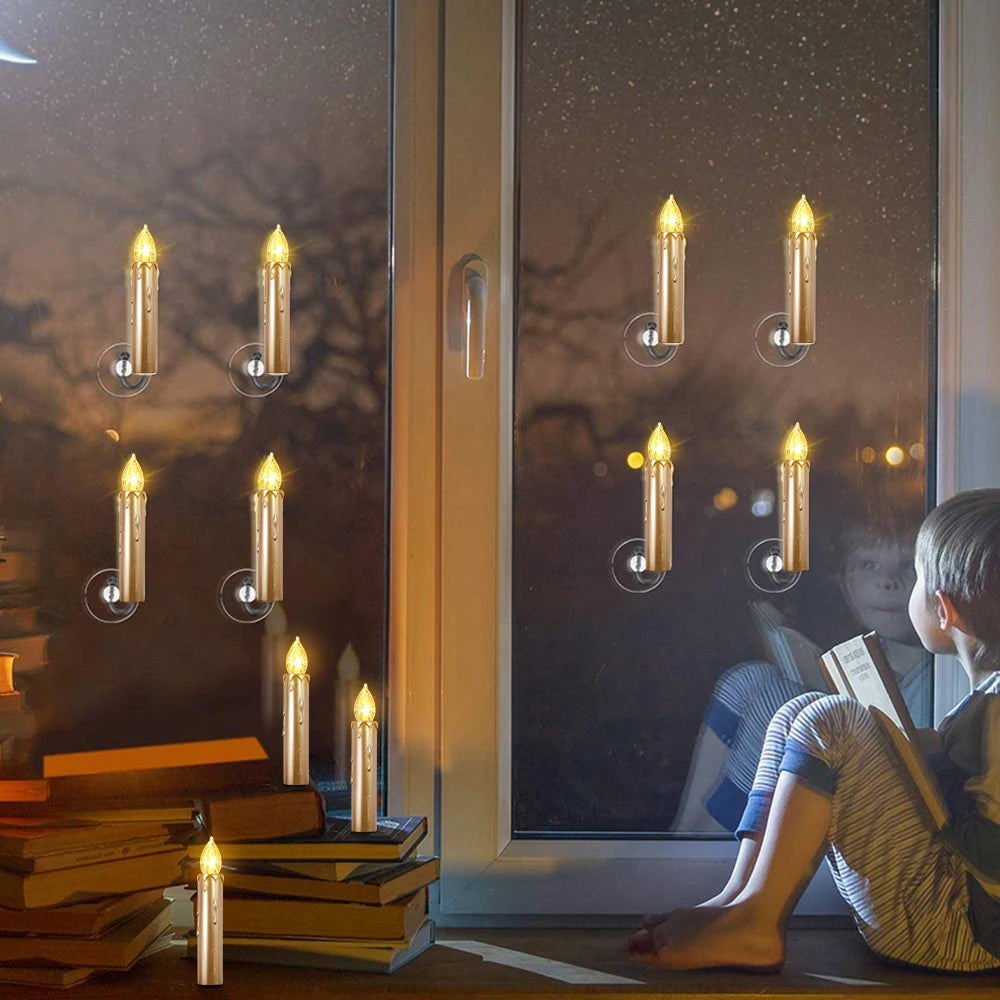 Person sitting by a window with candles and books, looking out at night.
