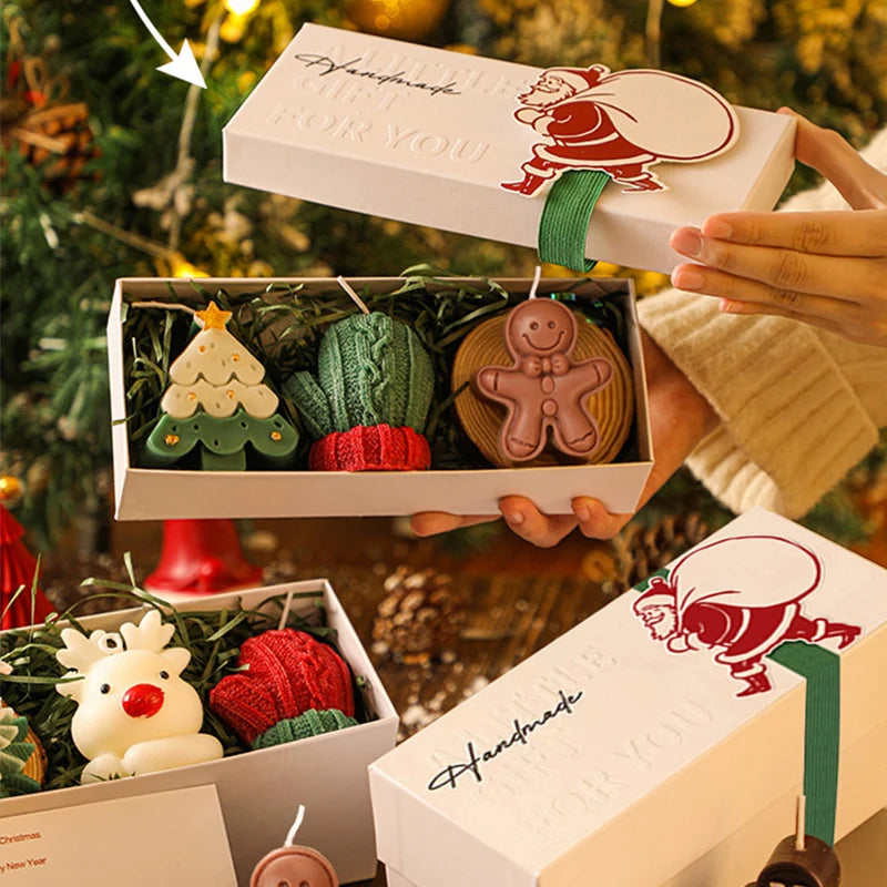 Handmade Christmas ornaments in a box with a decorative ribbon against a festive background.