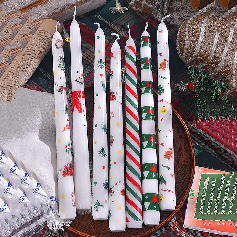 Set of Christmas-themed candles on a decorative surface with festive decor.