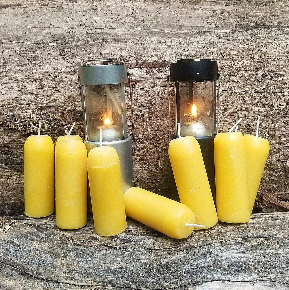 Yellow candles and lanterns on a wooden surface