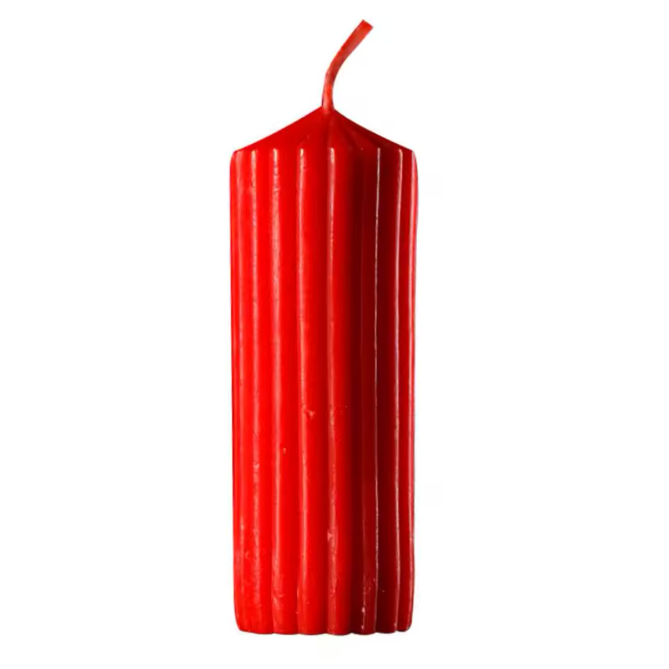 Red ribbed candle on a white background